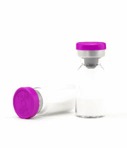 Vaccine vials with purple caps, medical storage containers for peptides or pharmaceuticals.